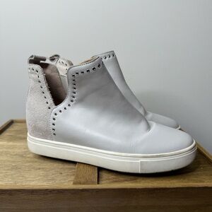 Chelsea & Violet Milo suede and leather eyelet wedge sneaker.